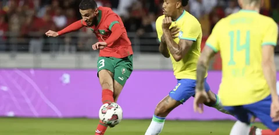 Moroccan player kicking the ball against Brazil