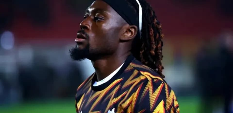 Player in patterned jersey during match warm-up