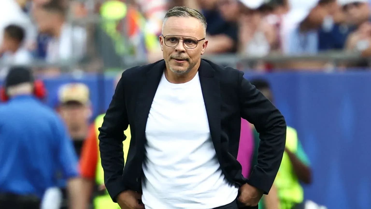 Coach walking along the sideline during a match