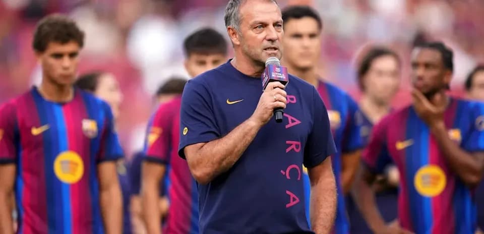 Coach speaking at press event with players behind