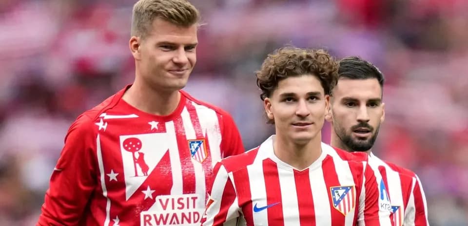 Atletico Madrid players in red and white jerseys