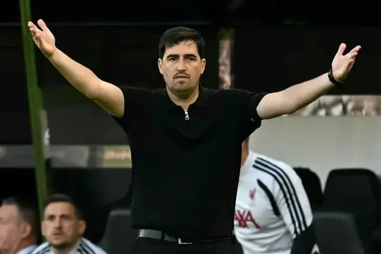 Coach gesturing on the sidelines during match