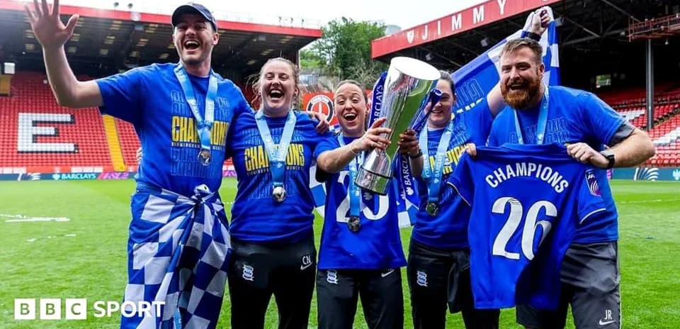 Team celebrating championship victory with trophy