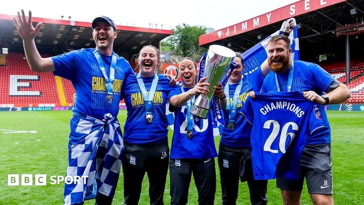 Team celebrating championship victory with trophy