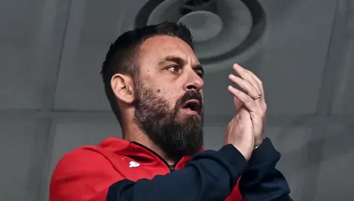 Man applauding from the stands during a match