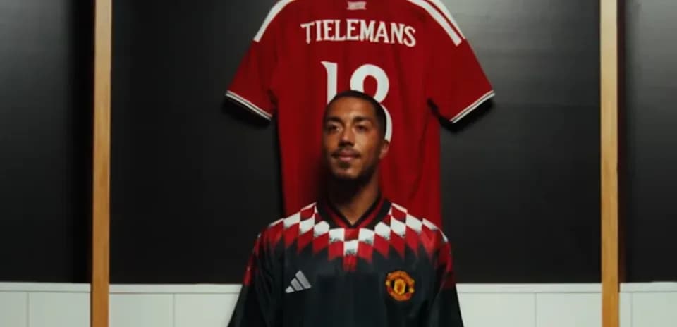 Player posing in front of jersey display
