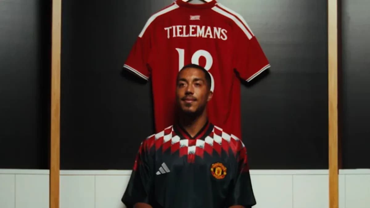 Player posing in front of jersey display