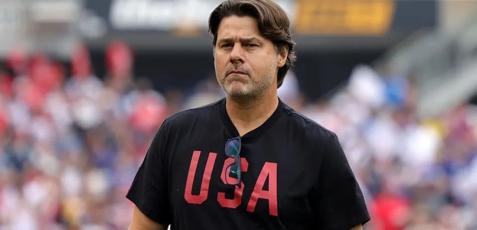 Coach wearing USA shirt on field during match