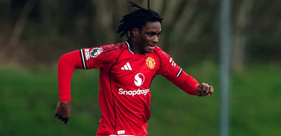 Player running on the field in Manchester United jersey