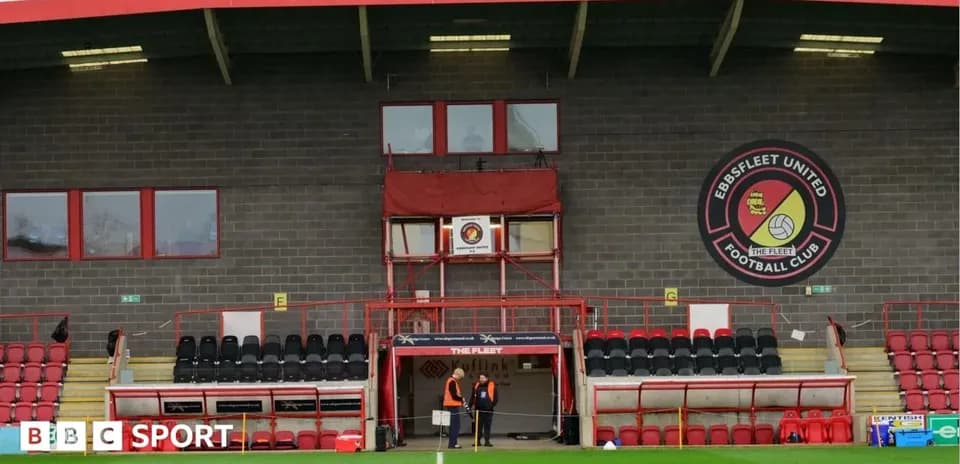 Ebbsfleet United stadium exterior with staff near entrance
