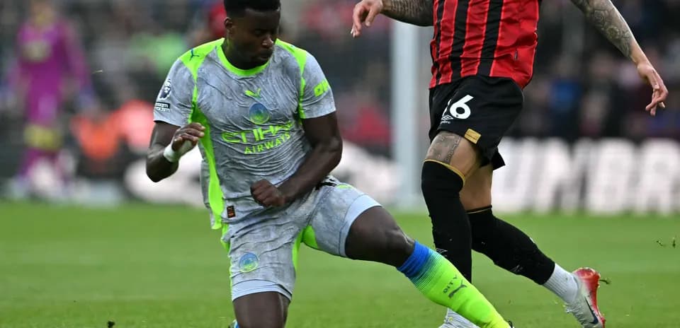 Manchester City player challenging Bournemouth opponent