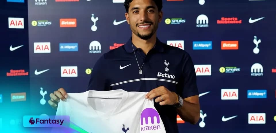Player holding Tottenham Hotspur jersey at presentation