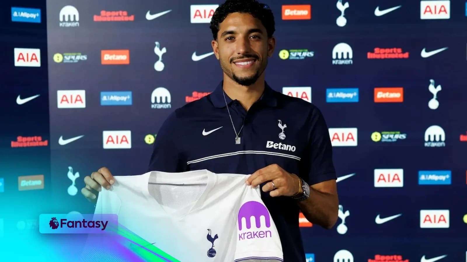 Player holding Tottenham Hotspur jersey at presentation