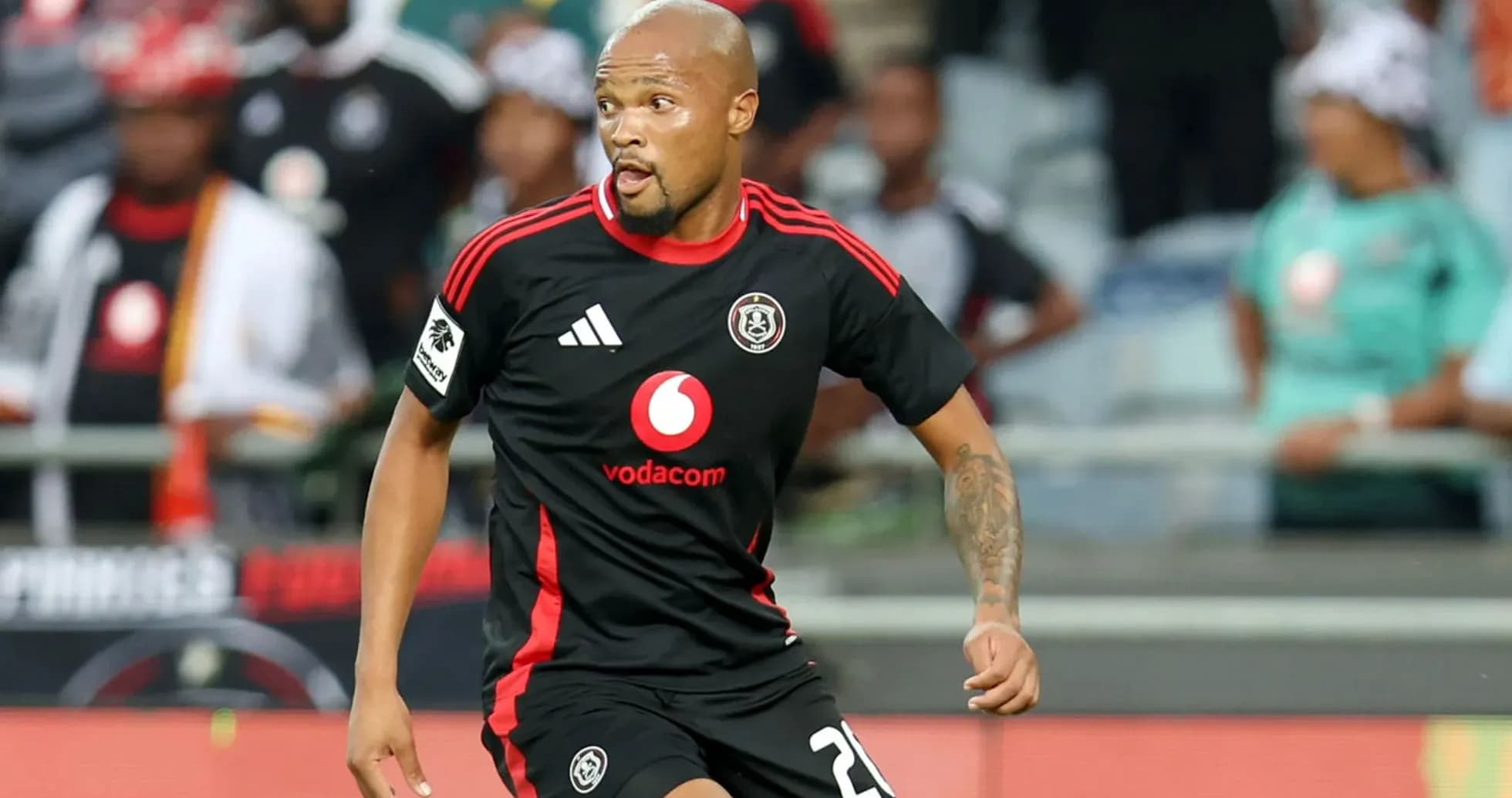 Player in black jersey running during a match