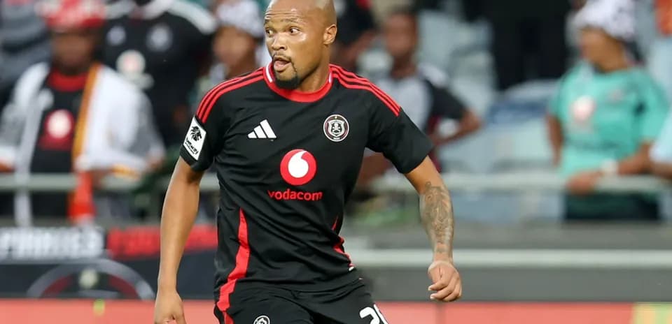 Player in black jersey running during a match