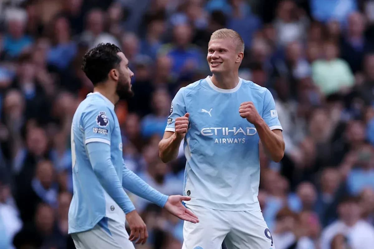 Two Manchester City players celebrating a goal