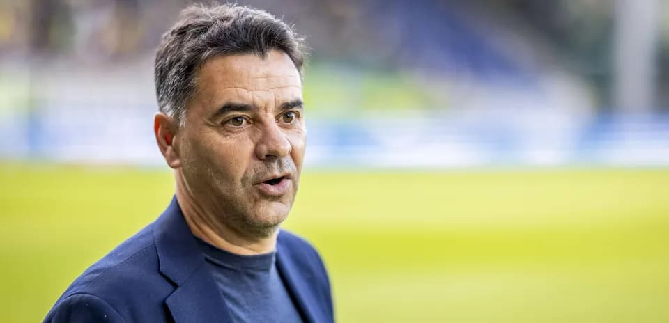 Coach speaking at a football match venue