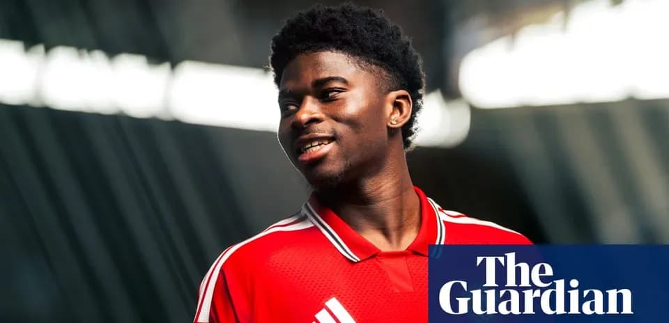 Player smiling in red jersey during photoshoot