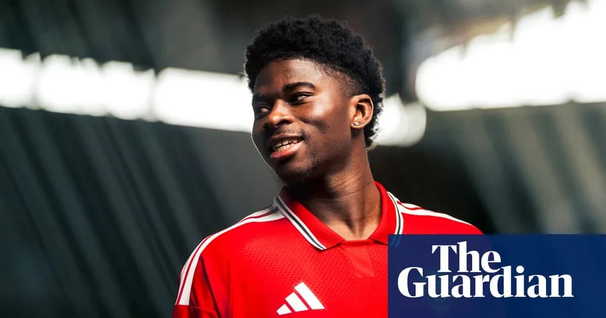 Player smiling in red jersey during photoshoot