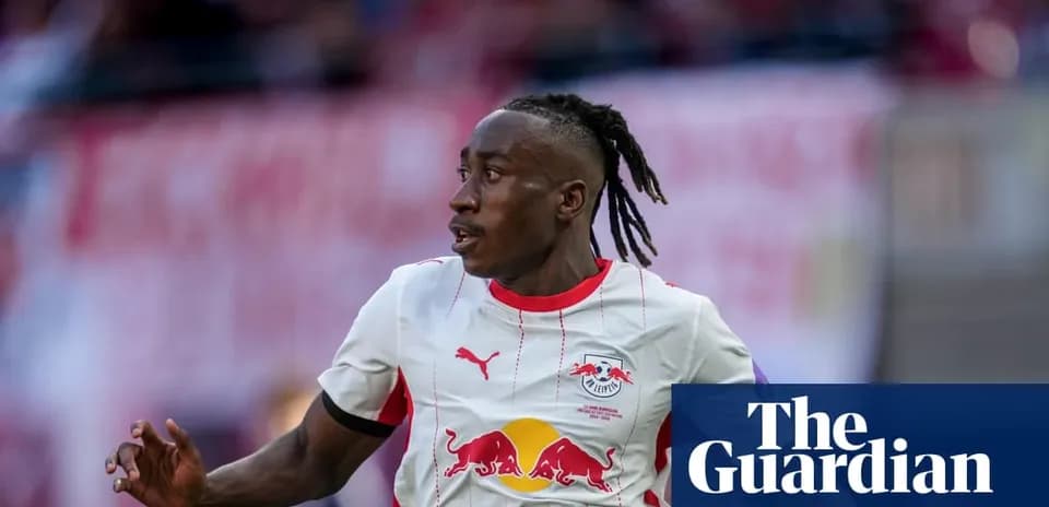 Player running during a match wearing RB Leipzig jersey