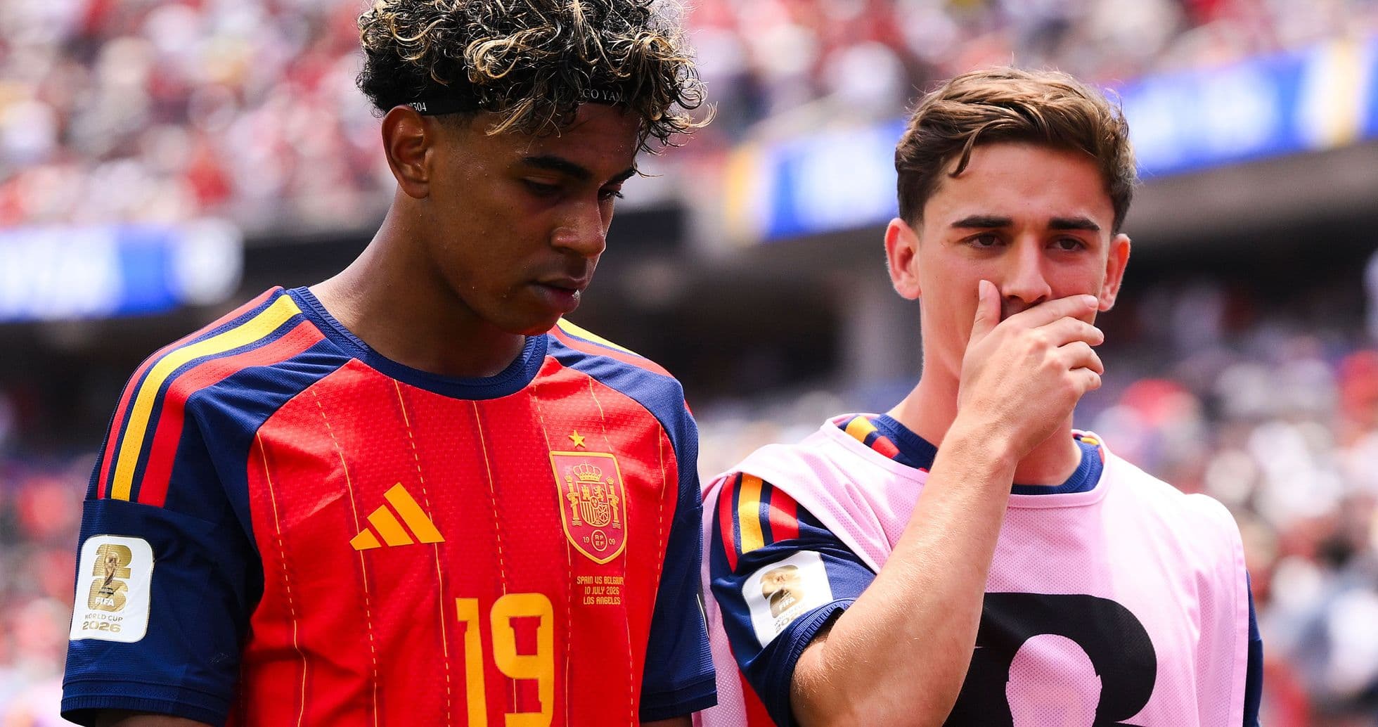 Two Spanish players on the sidelines during match