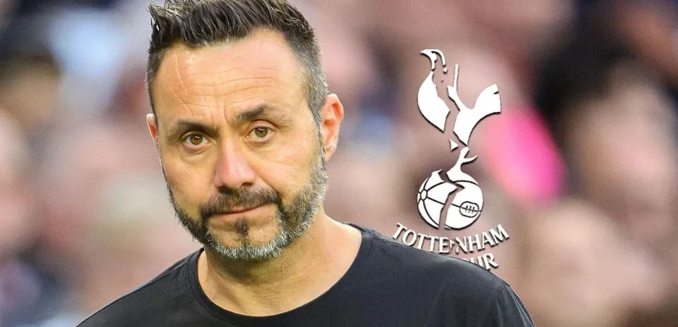 Manager looking serious with Tottenham Hotspur logo