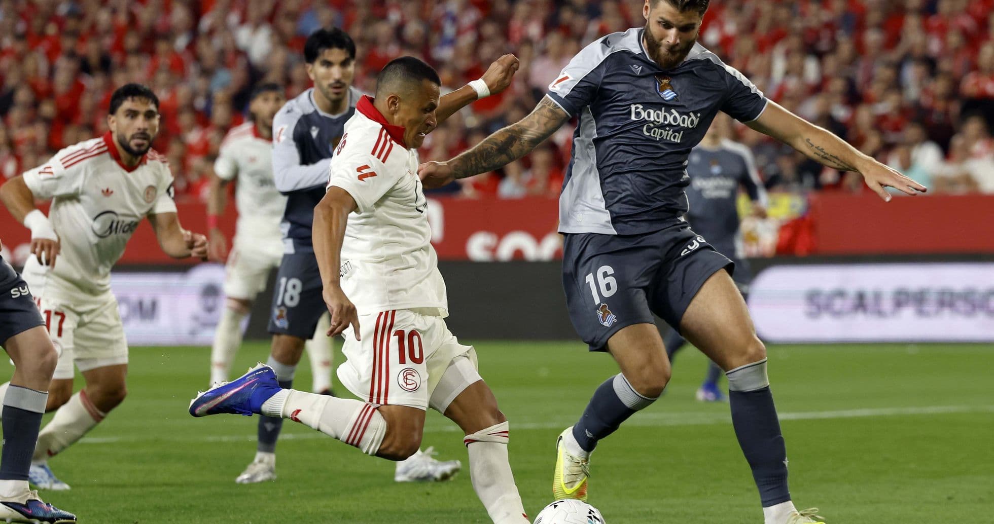 Sevilla player dribbling against Real Sociedad defender