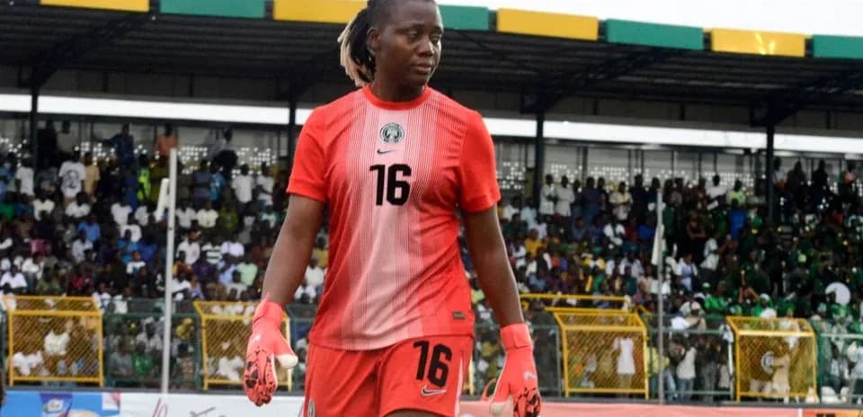 Goalkeeper in red kit walking on field