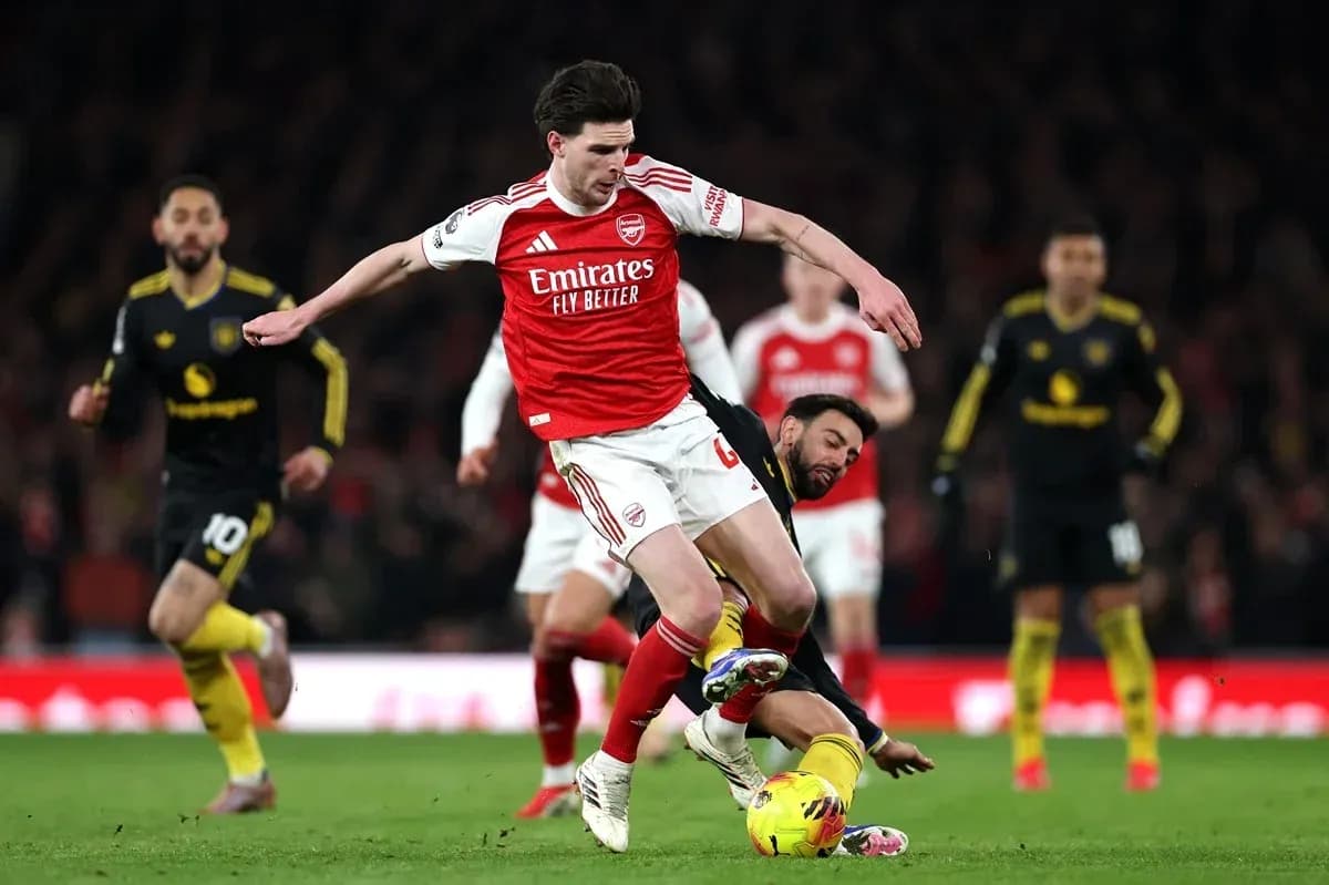Player from Arsenal evading tackle during match