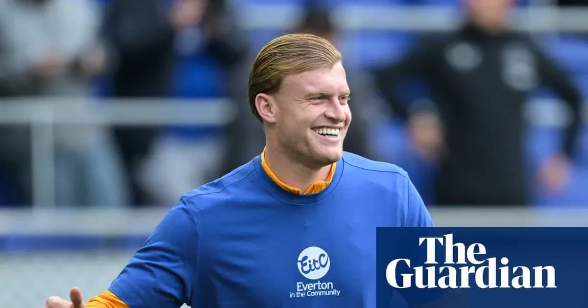 Player smiling during warm-up at Everton training