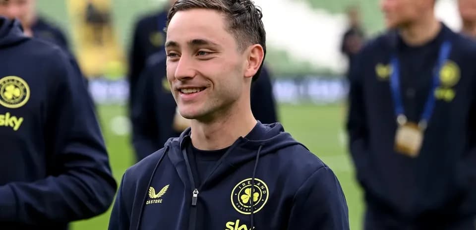 Player smiling in team training gear before match
