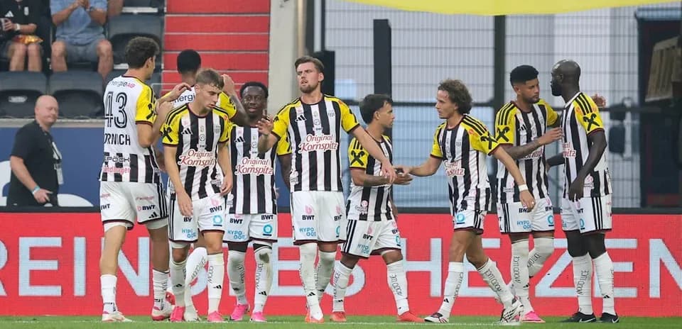 Players celebrating a goal on the pitch