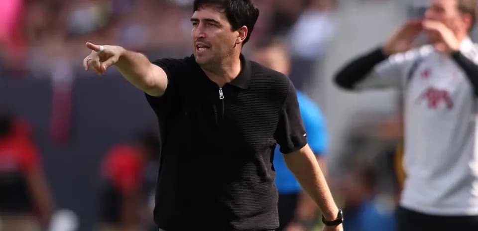 Coach giving instructions from the sidelines during match