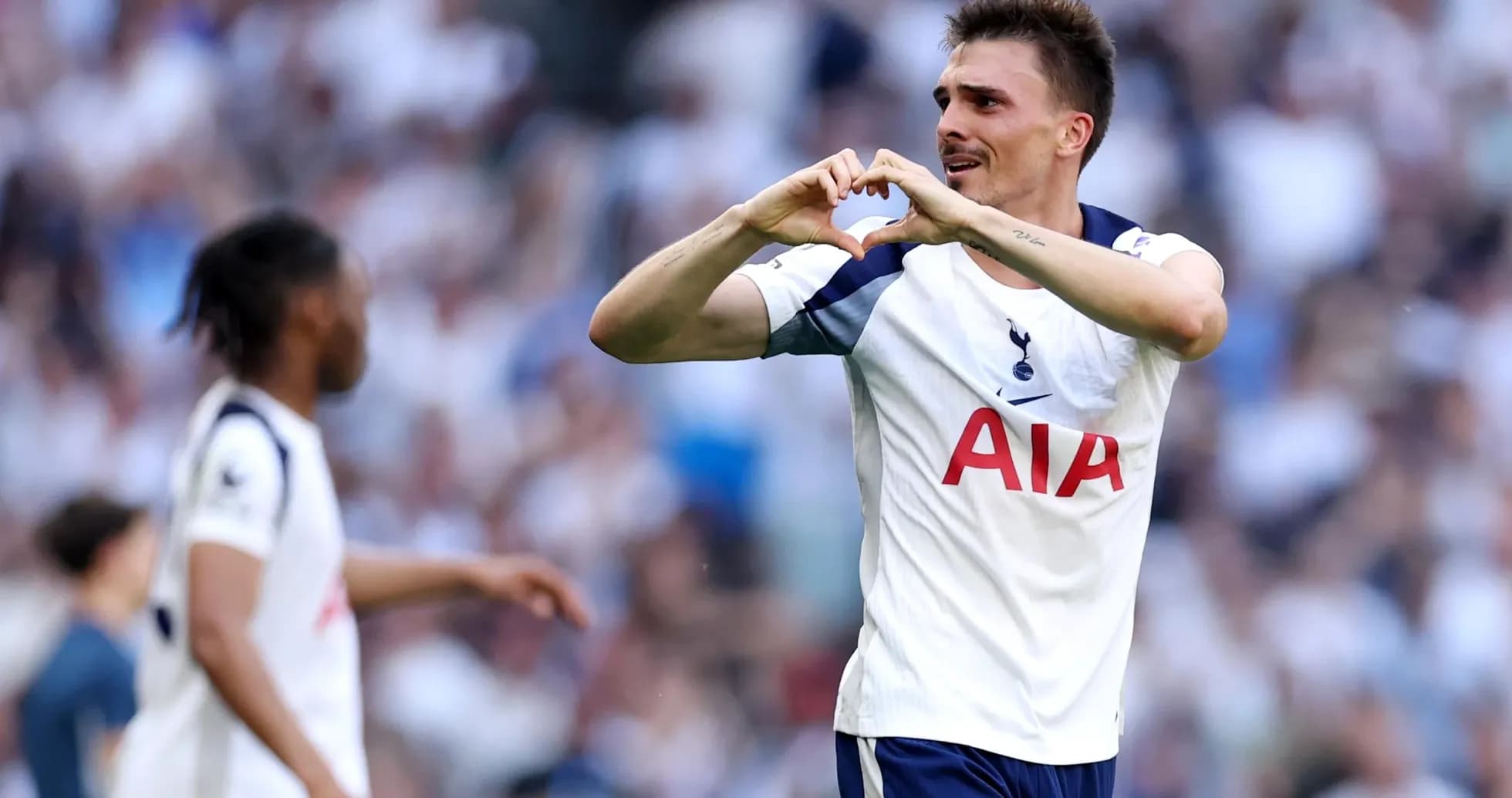 Player celebrating with heart gesture during match