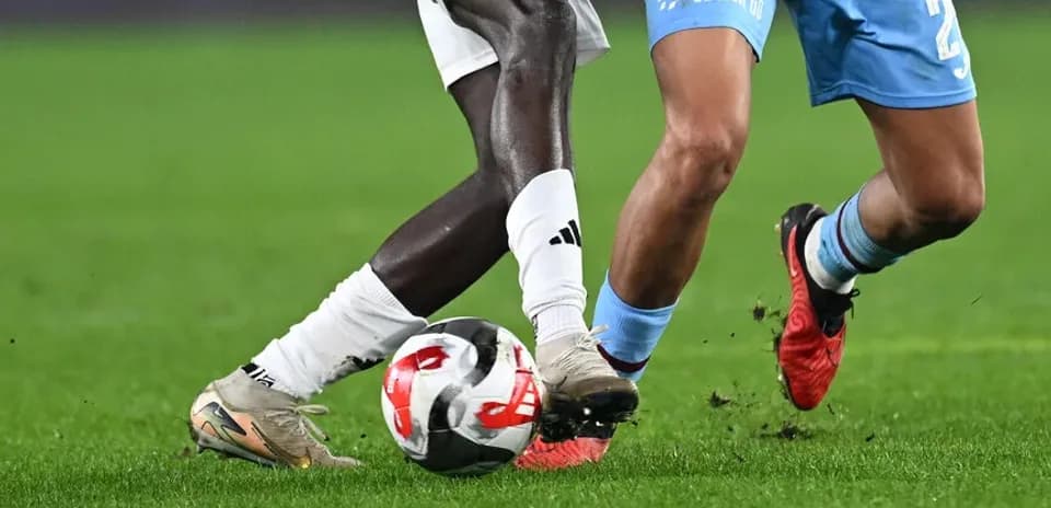 Two players competing for the ball on the field