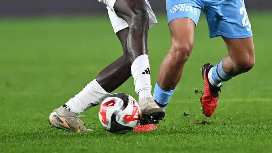 Two players competing for the ball on the field