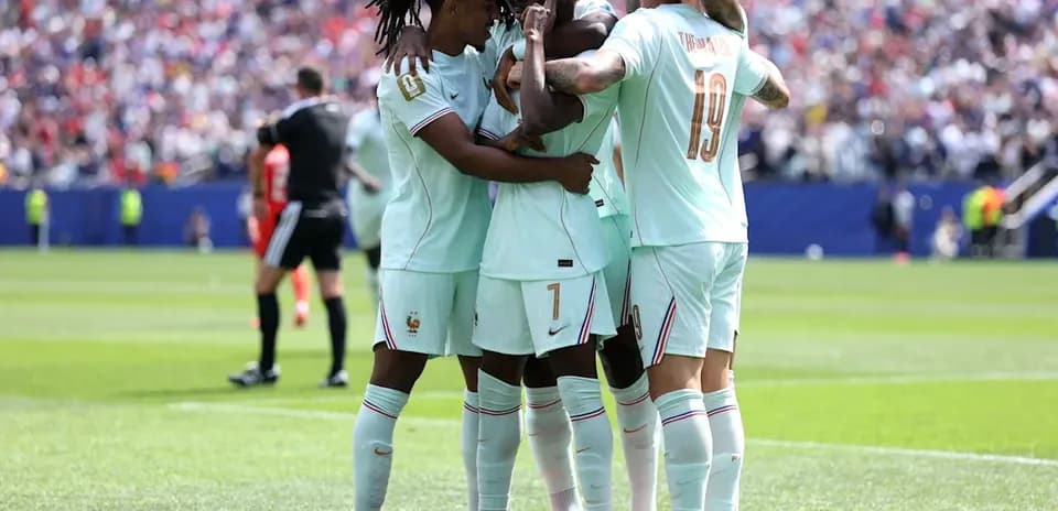 Players celebrating a goal on the field