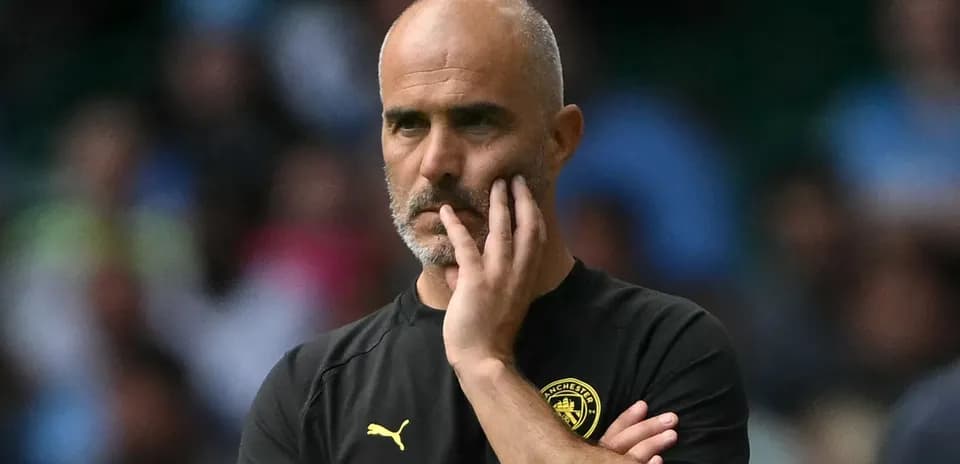 Coach observing the match with thoughtful expression