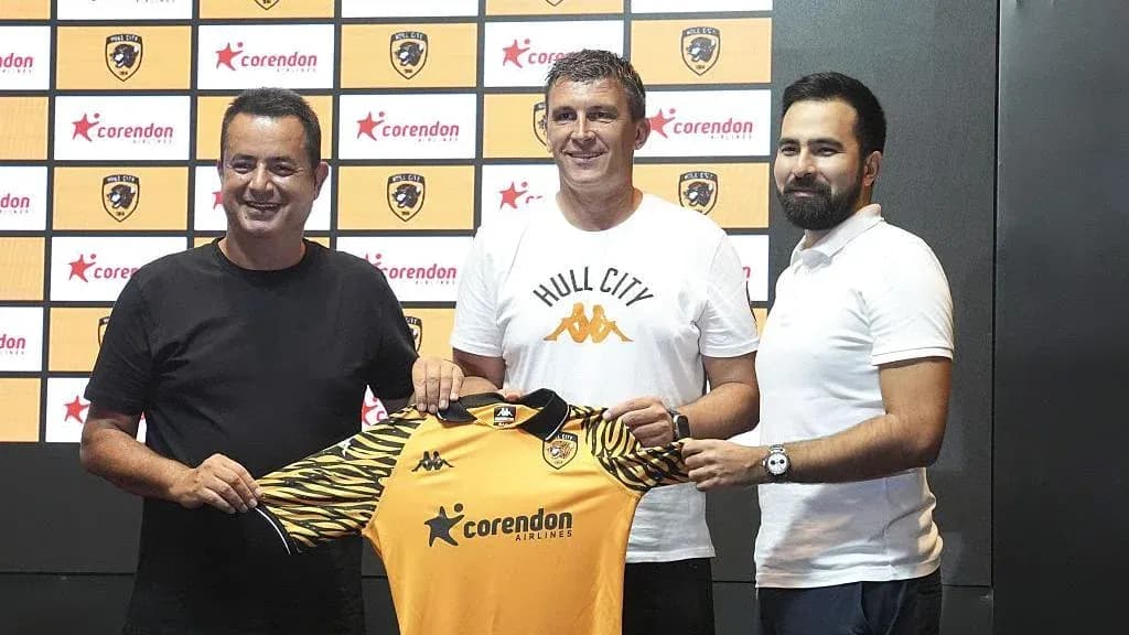 New coach presenting Hull City jersey at announcement