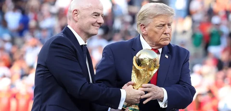 Gianni Infantino and Donald Trump holding FIFA World Cup trophy