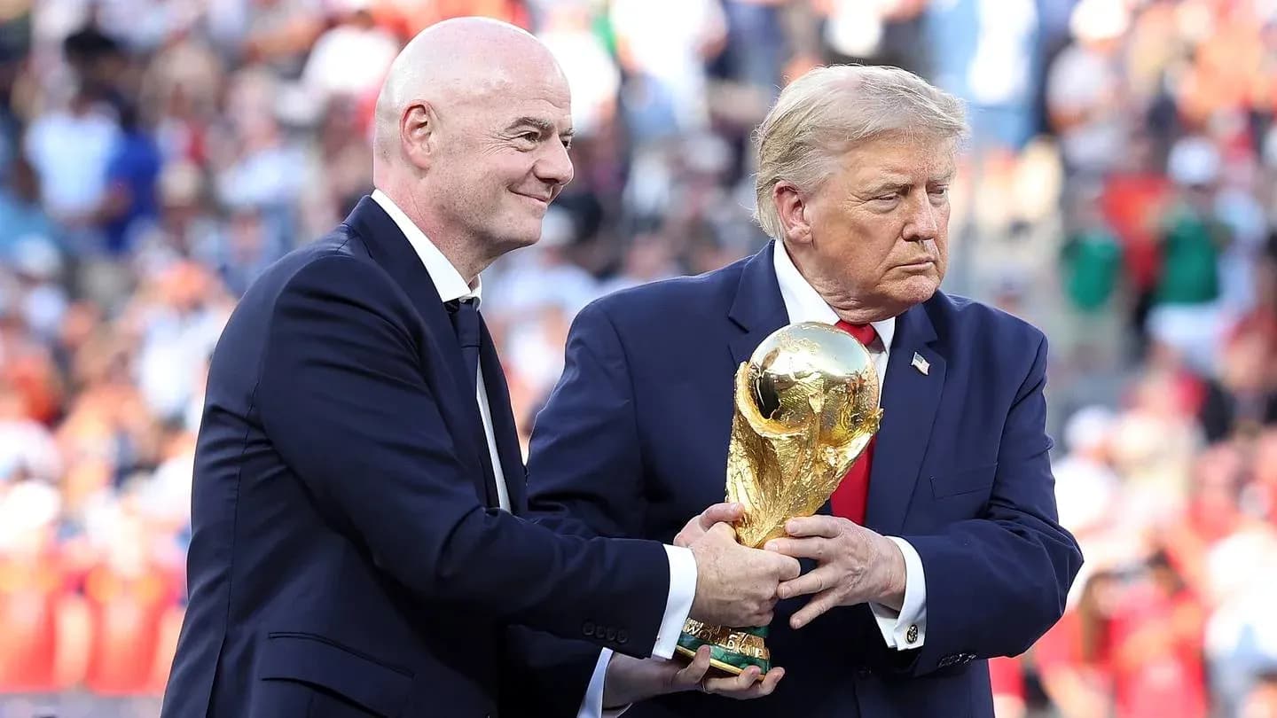Gianni Infantino and Donald Trump holding FIFA World Cup trophy