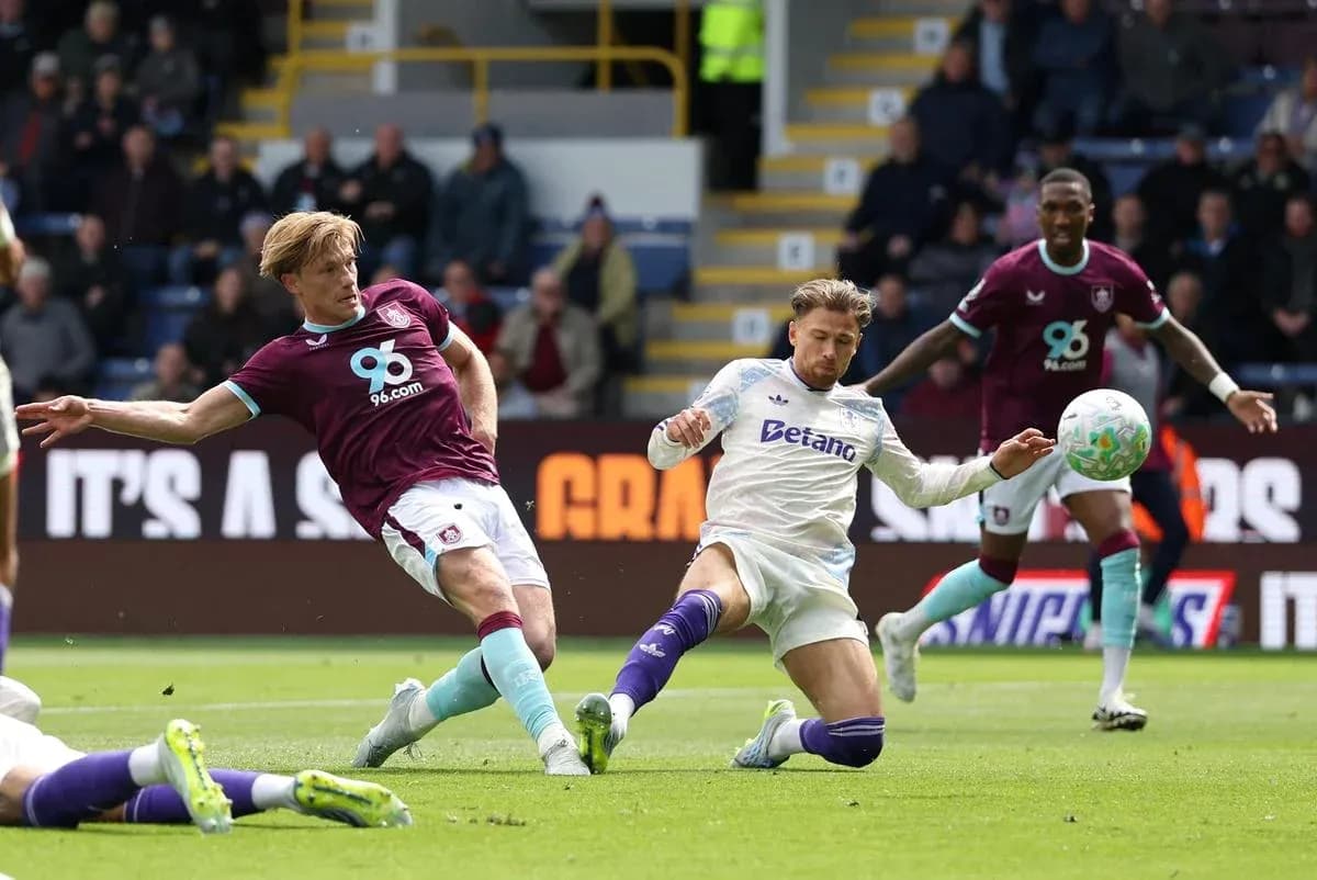 Burnley player tackling Aston Villa opponent