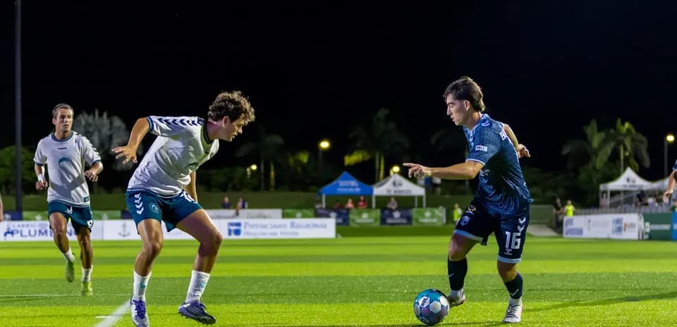 Player dribbling the ball during Naples vs Sarasota match