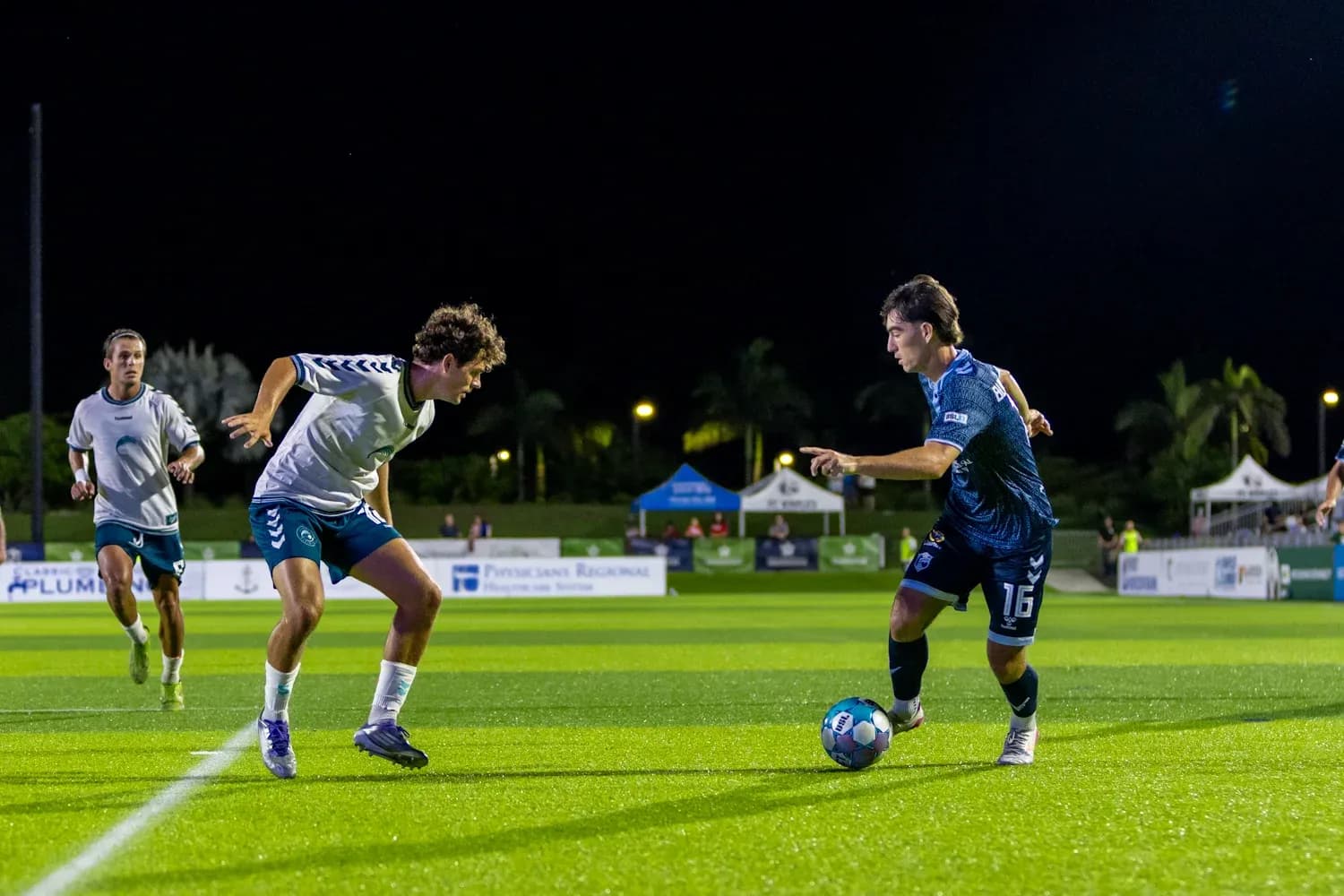 Player dribbling the ball during Naples vs Sarasota match