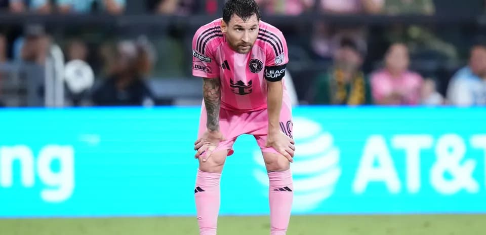 Player in pink uniform resting on the field
