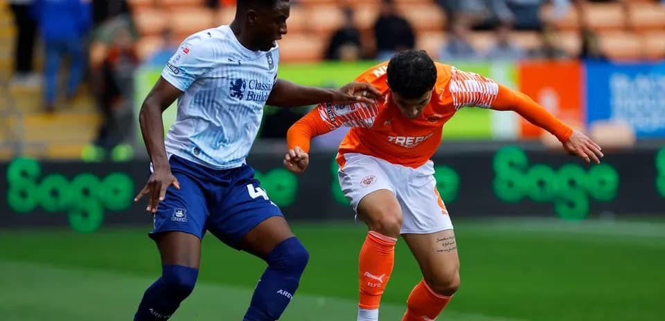 Two players contesting for the ball during match