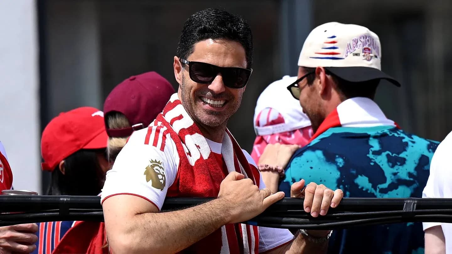 Man in sunglasses smiling with fans at event