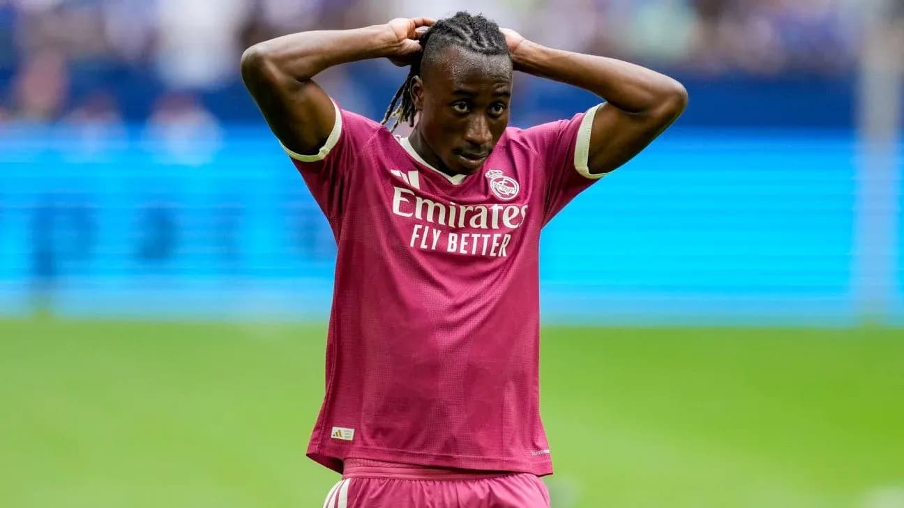 Player in pink jersey holding head during match