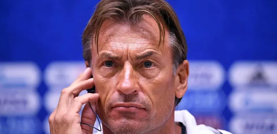 Coach listening during a press conference session