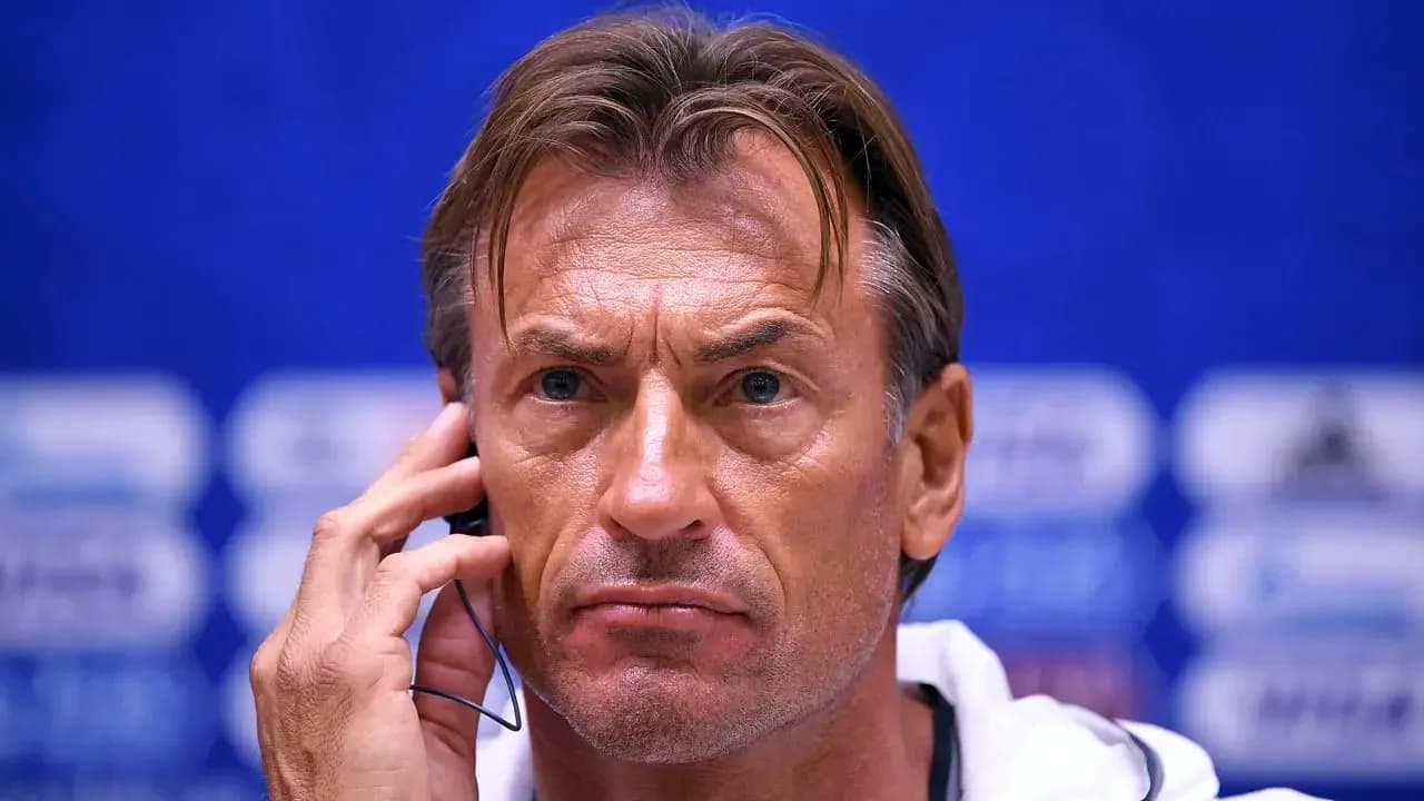 Coach listening during a press conference session